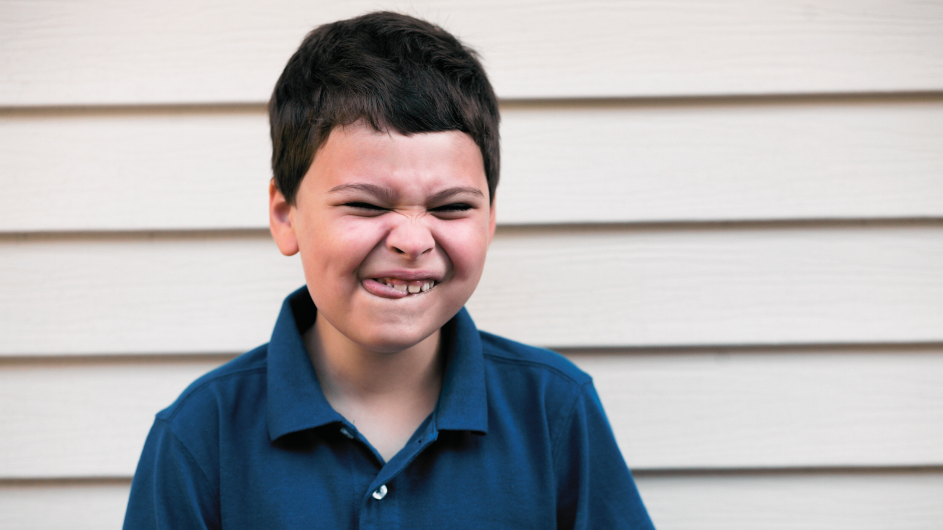 Young boy with profound disabilities smiling at Hope House in Liberty, TX