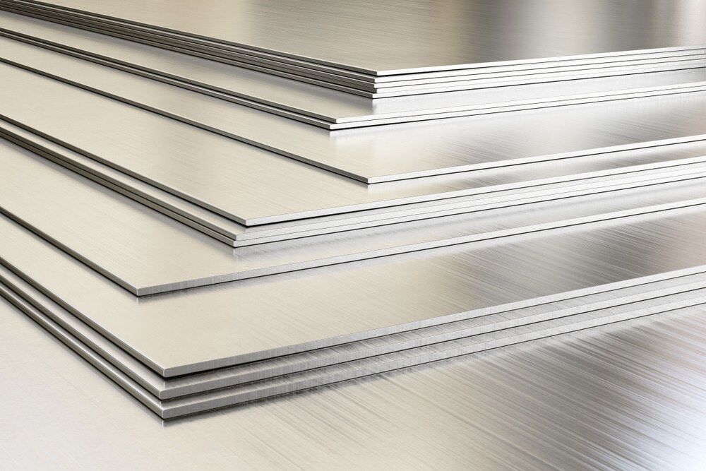 A Stack Of Aluminum Sheets Are Stacked On Top Of Each Other On A Table — Aliweld Fabrications In Caloundra West, QLD