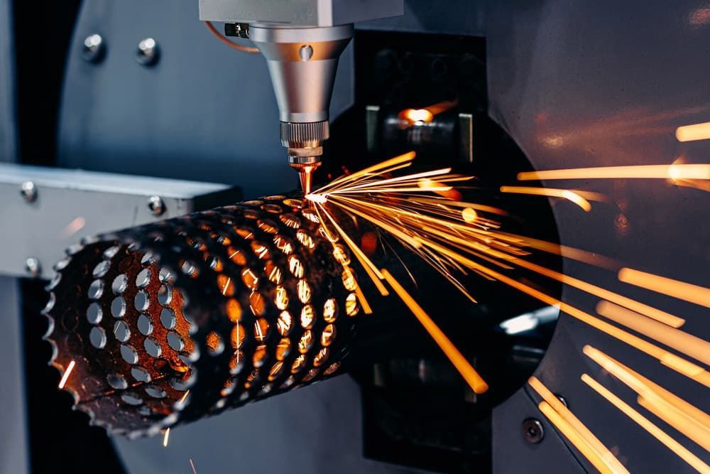 A Machine Is Cutting A Metal Pipe With Sparks Coming Out Of It — Aliweld Fabrications In Caloundra West, QLD