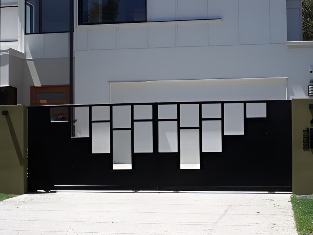 A Black Sliding Gate With Squares Cut Out Of It — Aliweld Fabrications In Caloundra West, QLD
