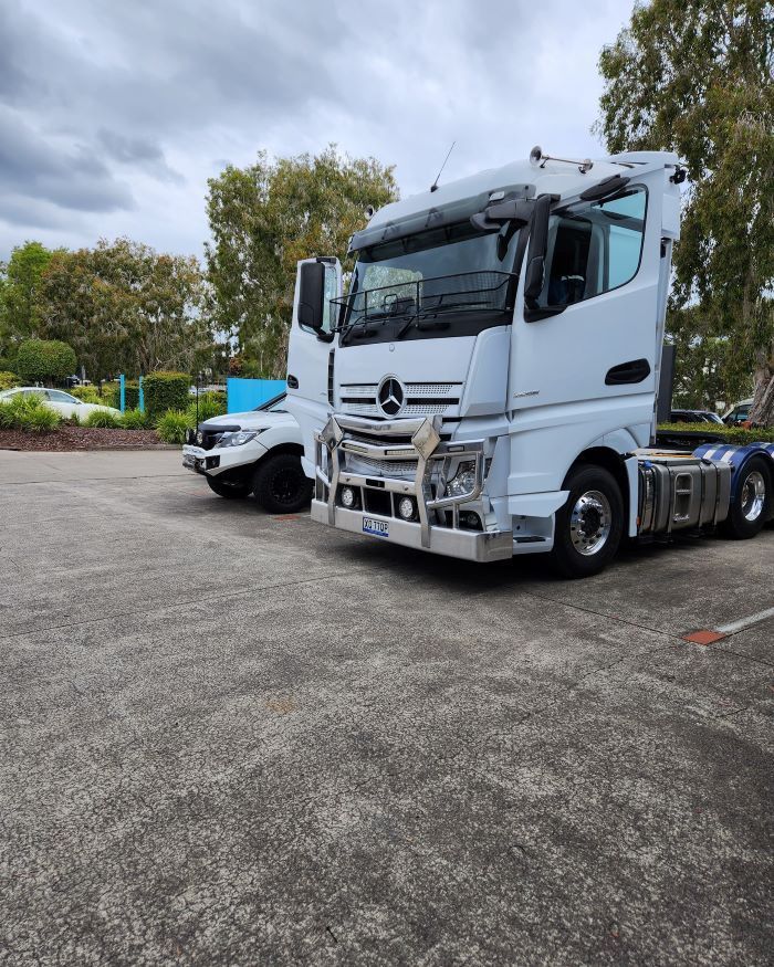 A White Semi Truck is Parked Next to a Parking Lot — Smart Automotive Technologies in Noosaville, QLD