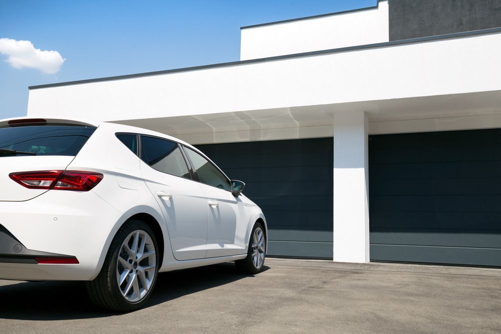 A White Car is Parked in Front of a White House — Smart Automotive Technologies in Noosaville, QLD