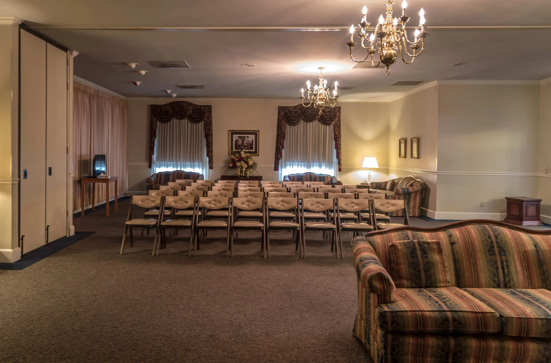 a large room with rows of chairs and a couch