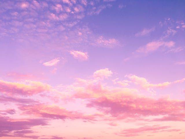 A pastel sky filled with soft pink clouds brings a calm and comforting touch to cremation services Harvey, LA