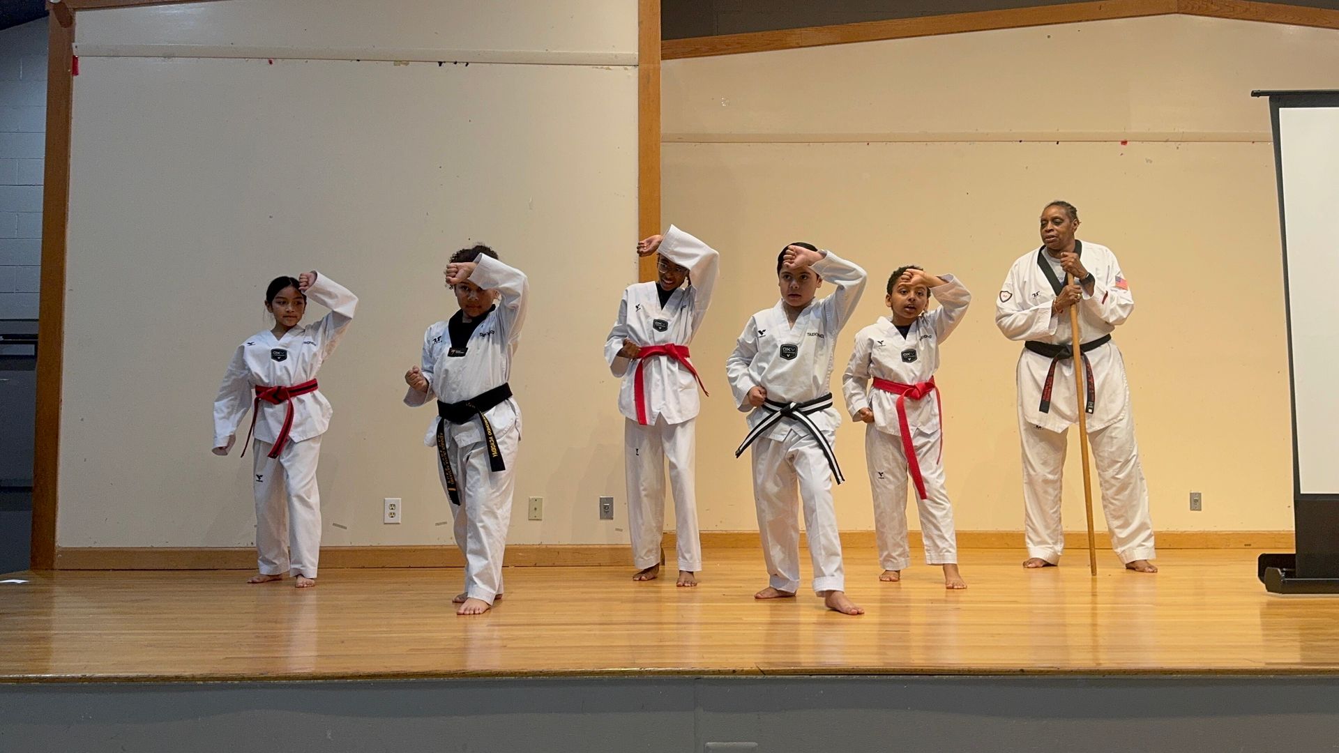 A group of people are practicing martial arts on a stage.