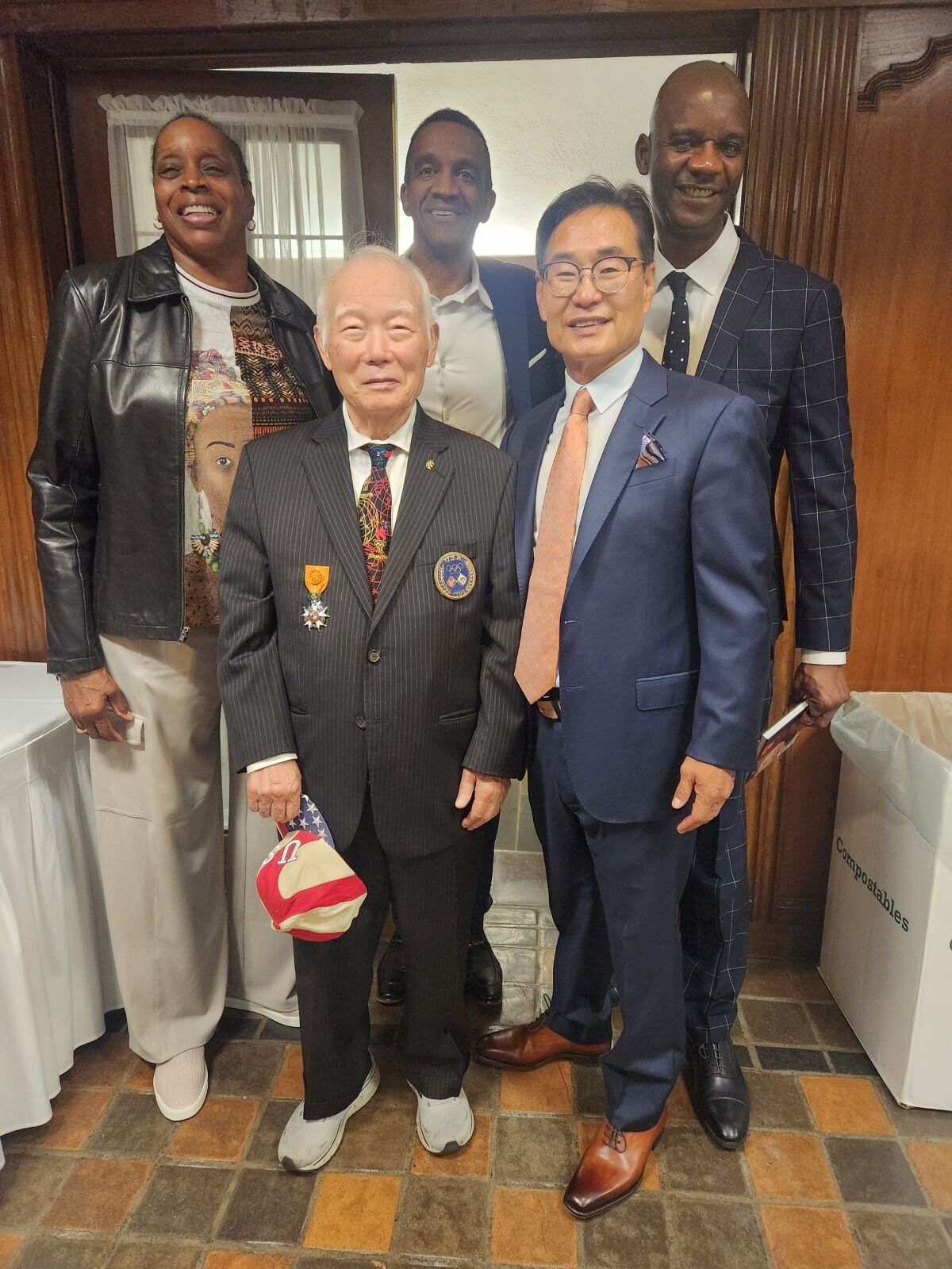A group of people in suits and ties are posing for a picture.