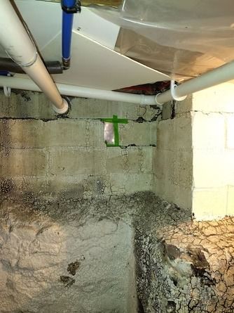 Concrete block basement wall showing mortar joint cracks.