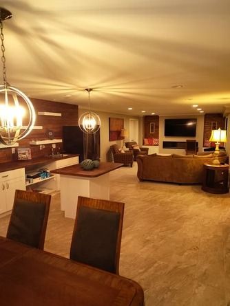 An open-concept living area with a kitchen, dining space, and a living room.