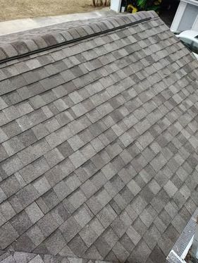 A high-angle view of a grey architectural asphalt shingle roof.