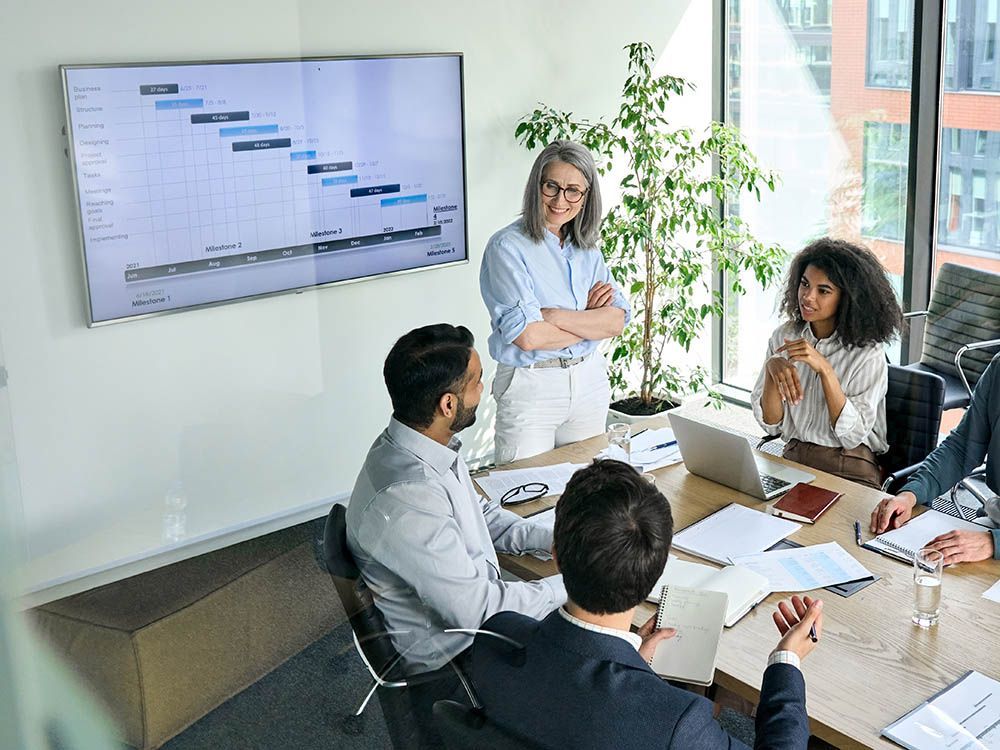 A group of business people are having a meeting in a conference room.