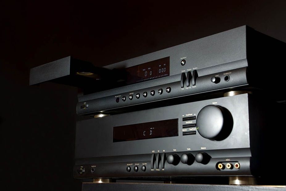 A stack of stereo equipment including a receiver and a cd player