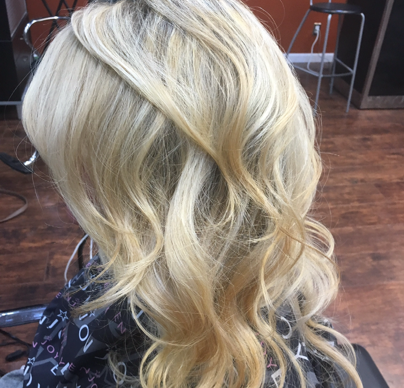 A woman with blonde hair is sitting in a chair