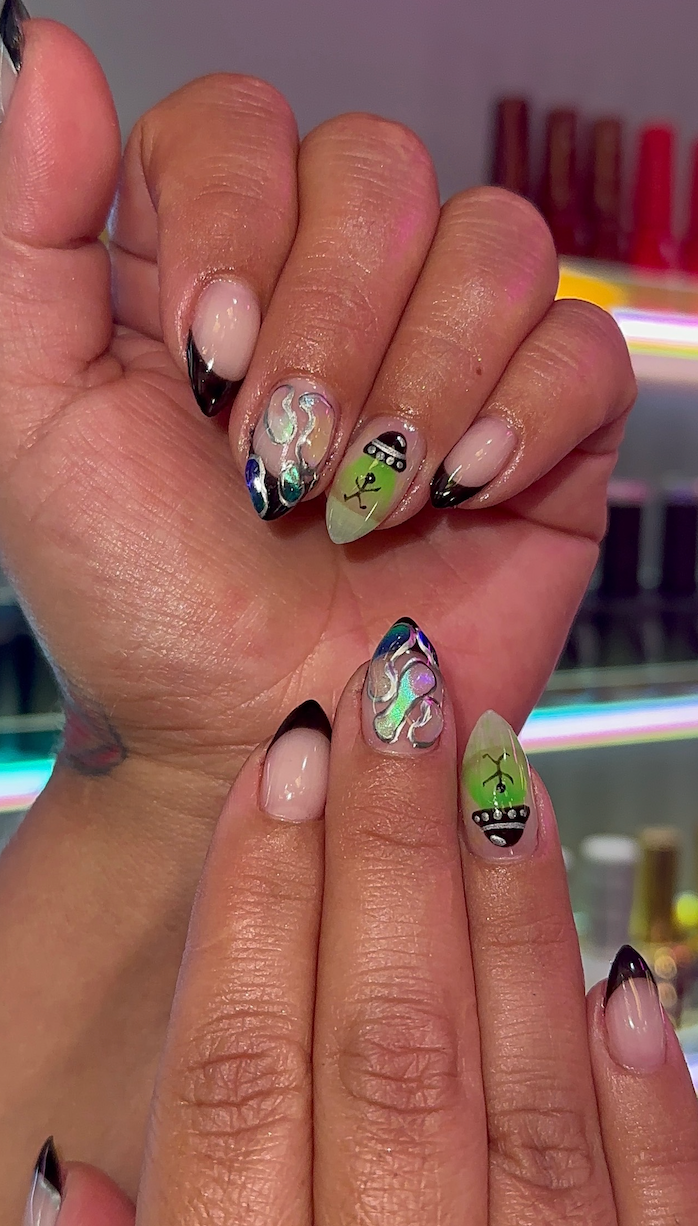 A close up of a person 's nails with a design on them.