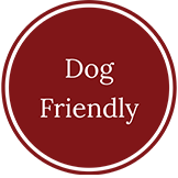A red circle with the words `` dog friendly '' written inside of it.