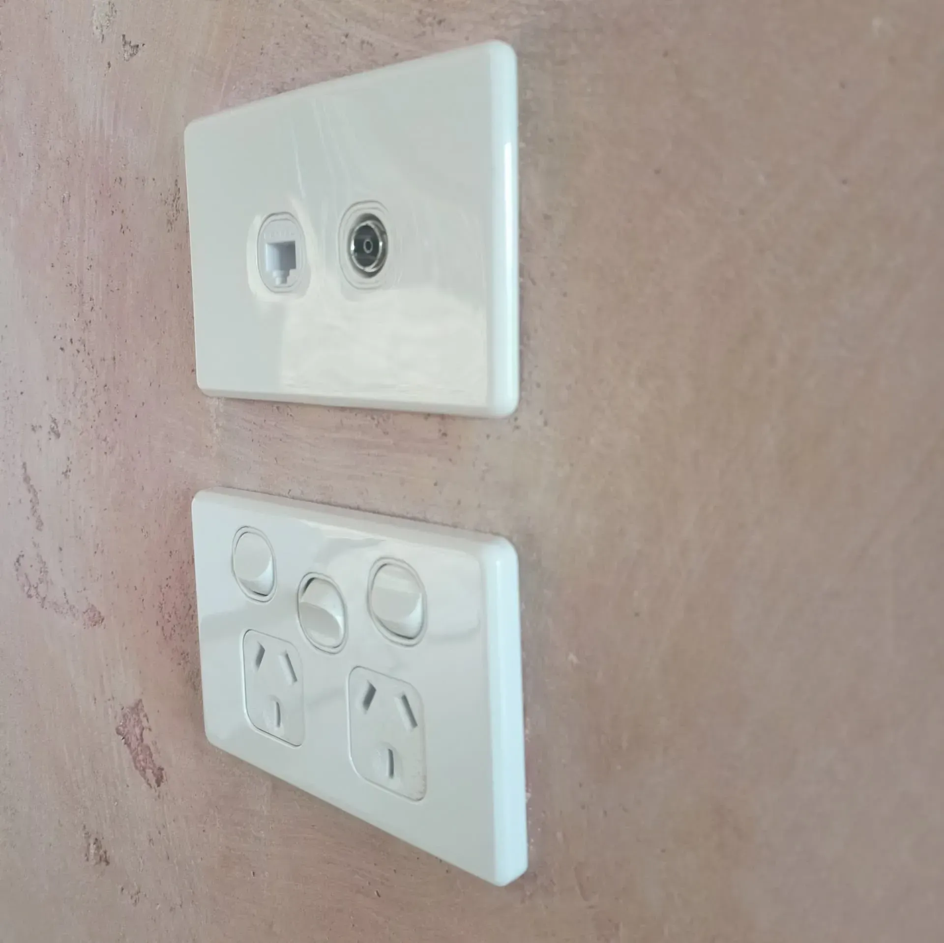 Two White Electrical Outlets are Mounted on a Wall — Bangalow Electrical in Bangalow, NSW