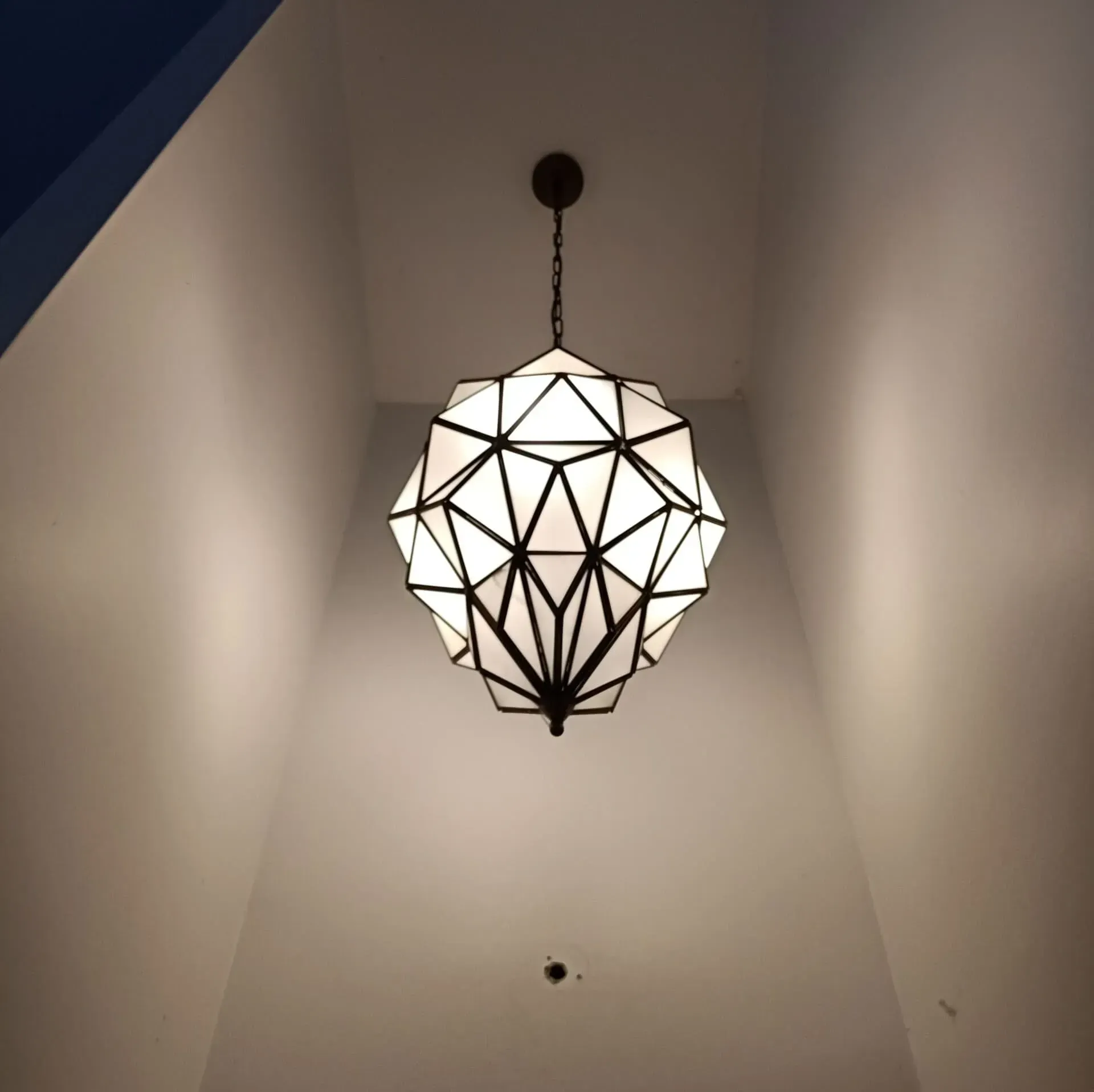 A Chandelier is Hanging From the Ceiling in a Dark Room — Bangalow Electrical in Bangalow, NSW