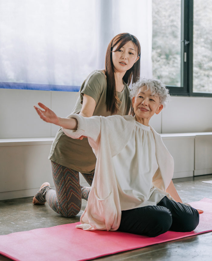 2 women stretching as an illustration for psychological flexibility