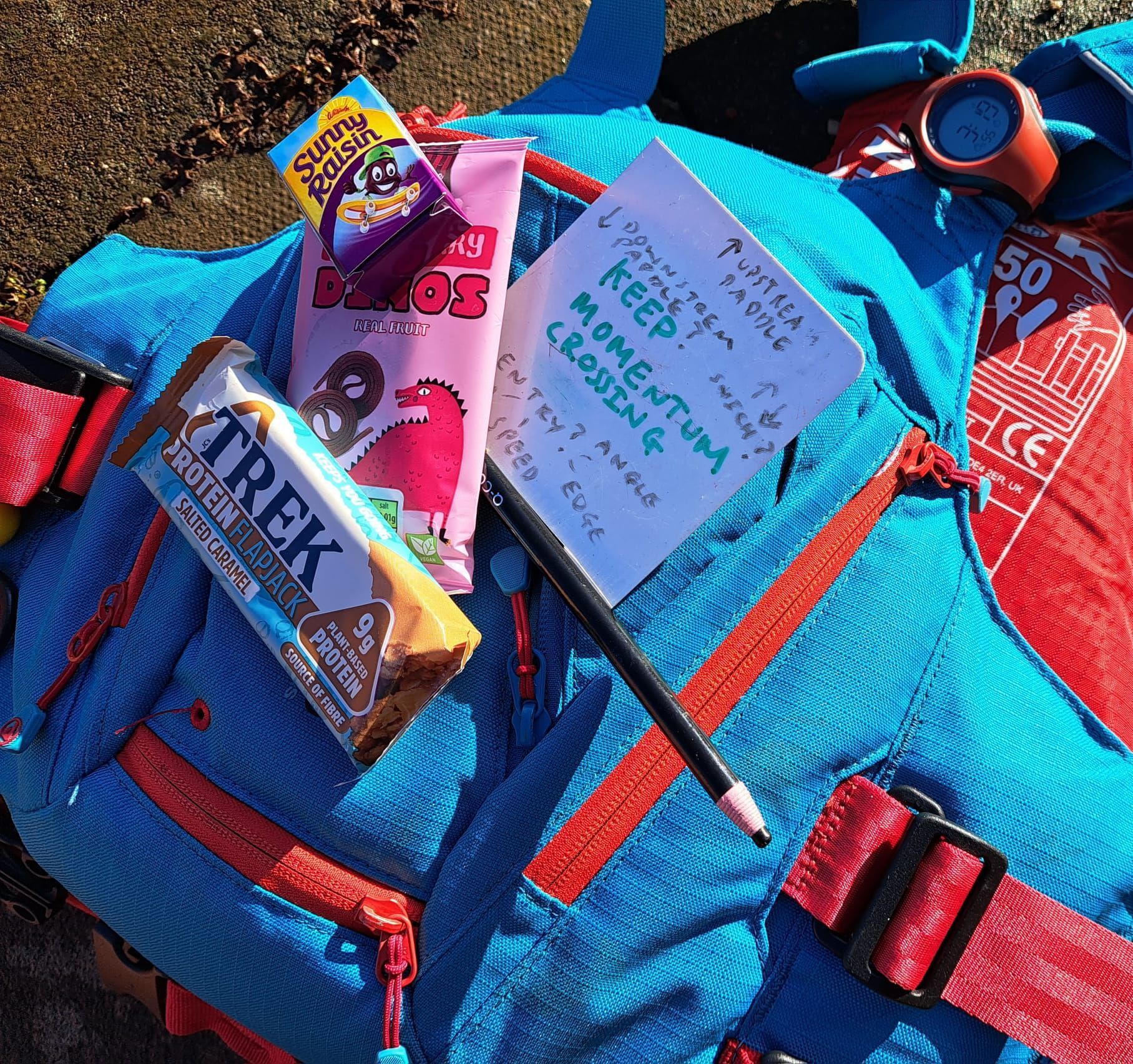 Blue backpack with snacks, a note that says
