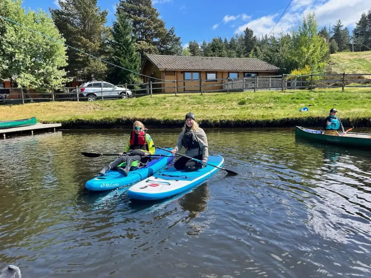 A group of people are riding kayaks on a river.