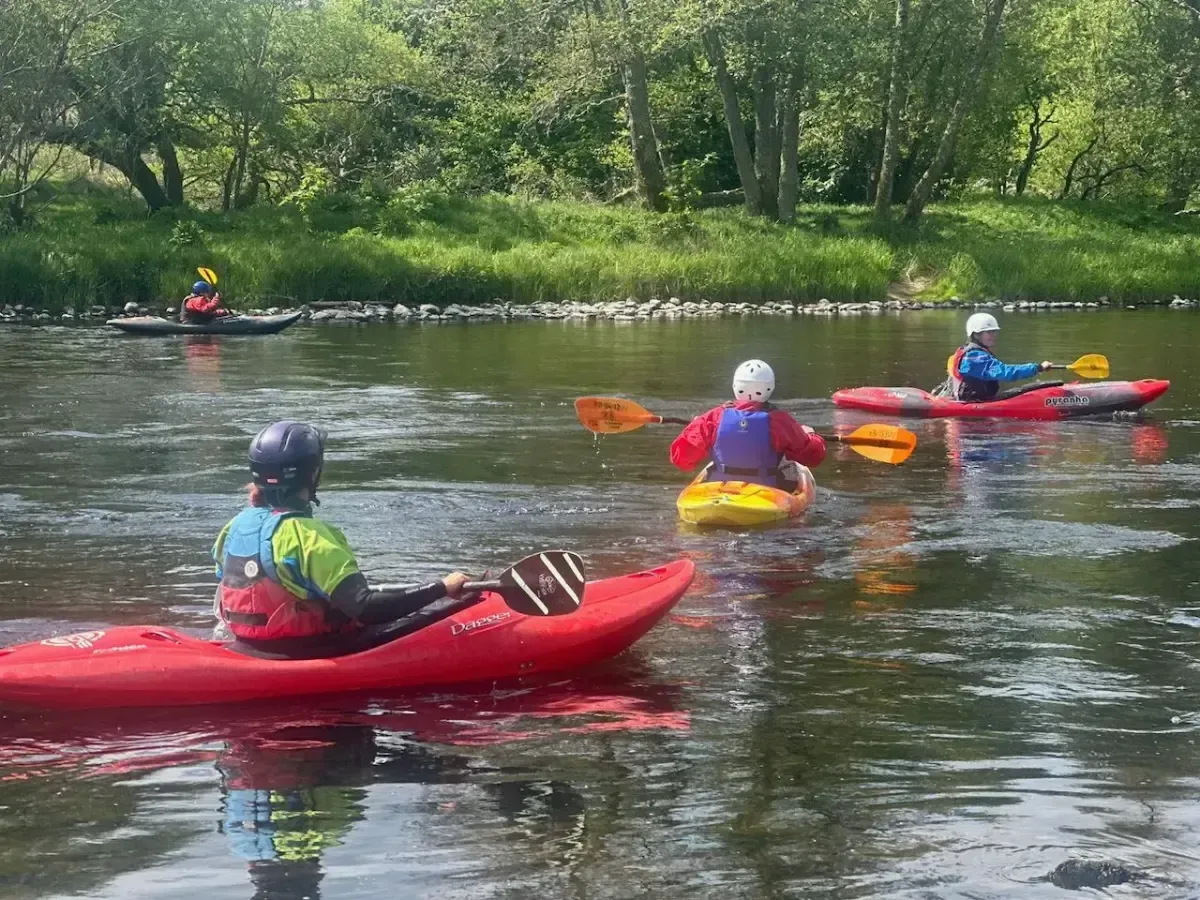 A group of people are kayaking down a river.