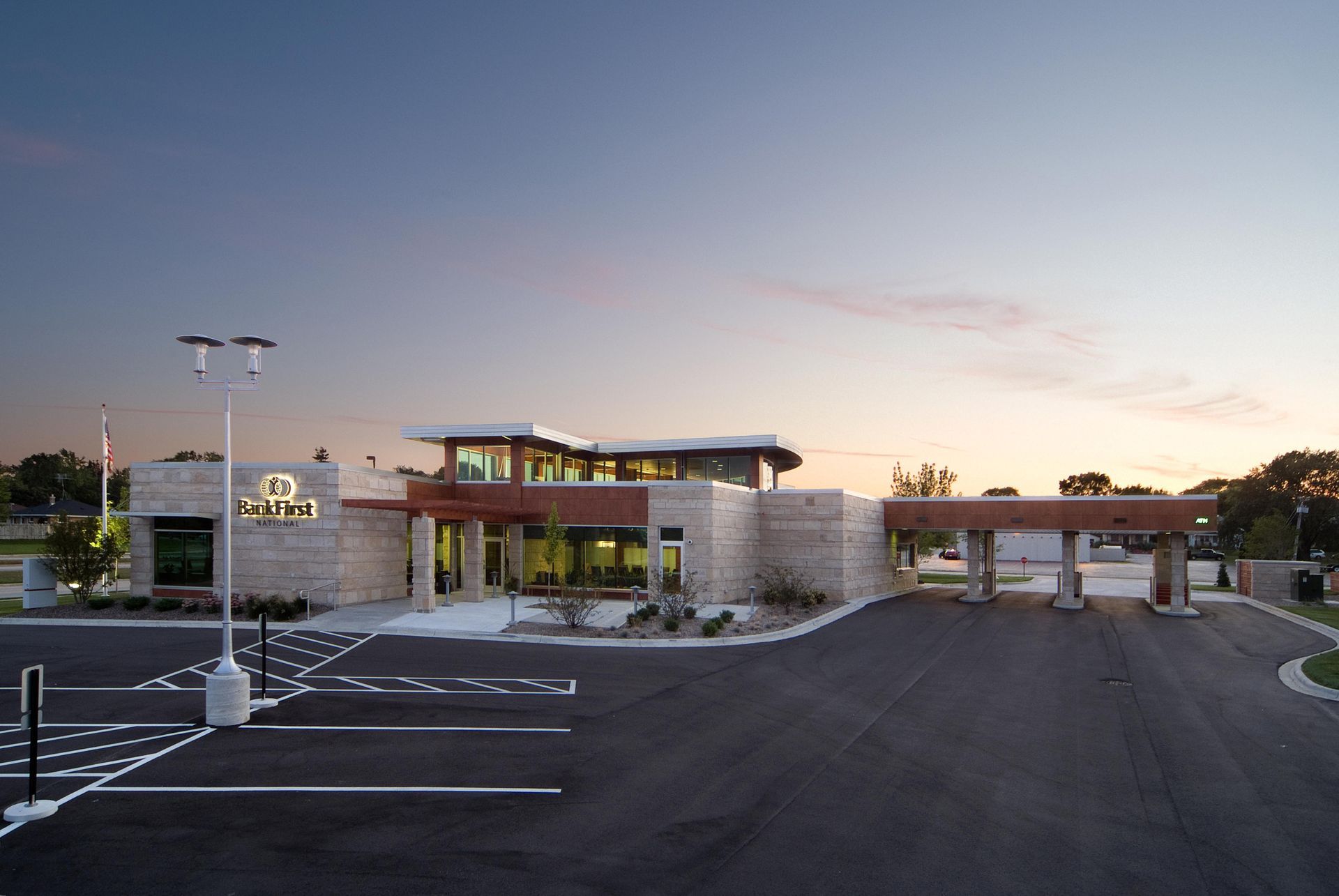 A Large Building with A Lot of Windows and A Parking Lot in Front of It | Sheboygan, WI | Elite Builds