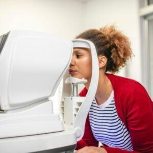 A woman is getting her eyes checked by an ophthalmologist.