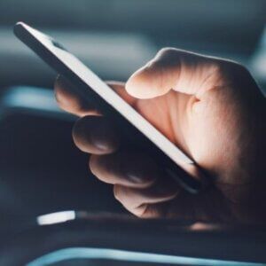 A person is holding a cell phone in their hand.