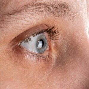 A close up of a person 's eye with blue eyes.