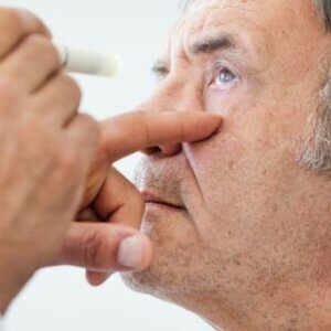 A man is getting his eyes examined by a doctor.