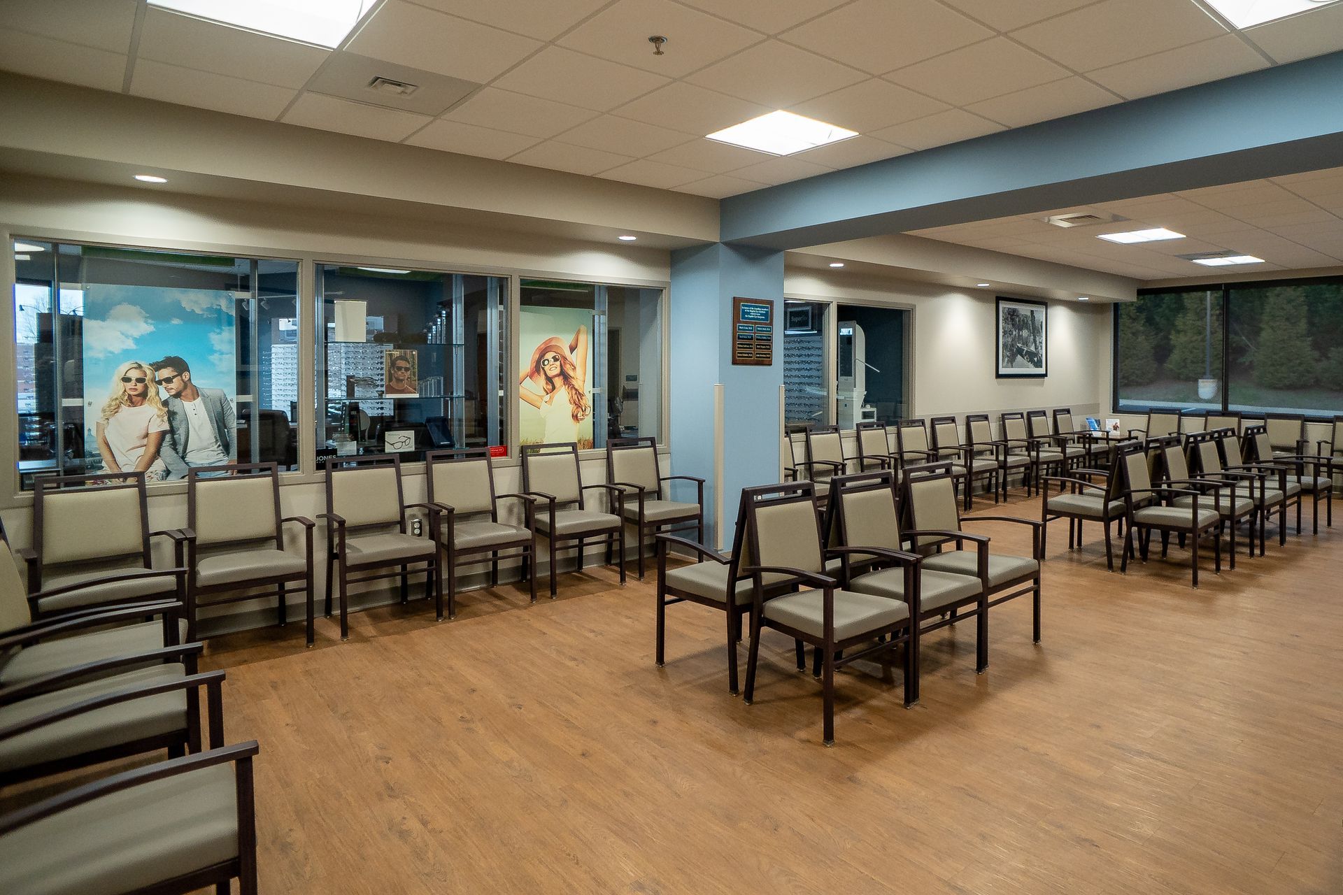 There are many chairs in the waiting room of a hospital.