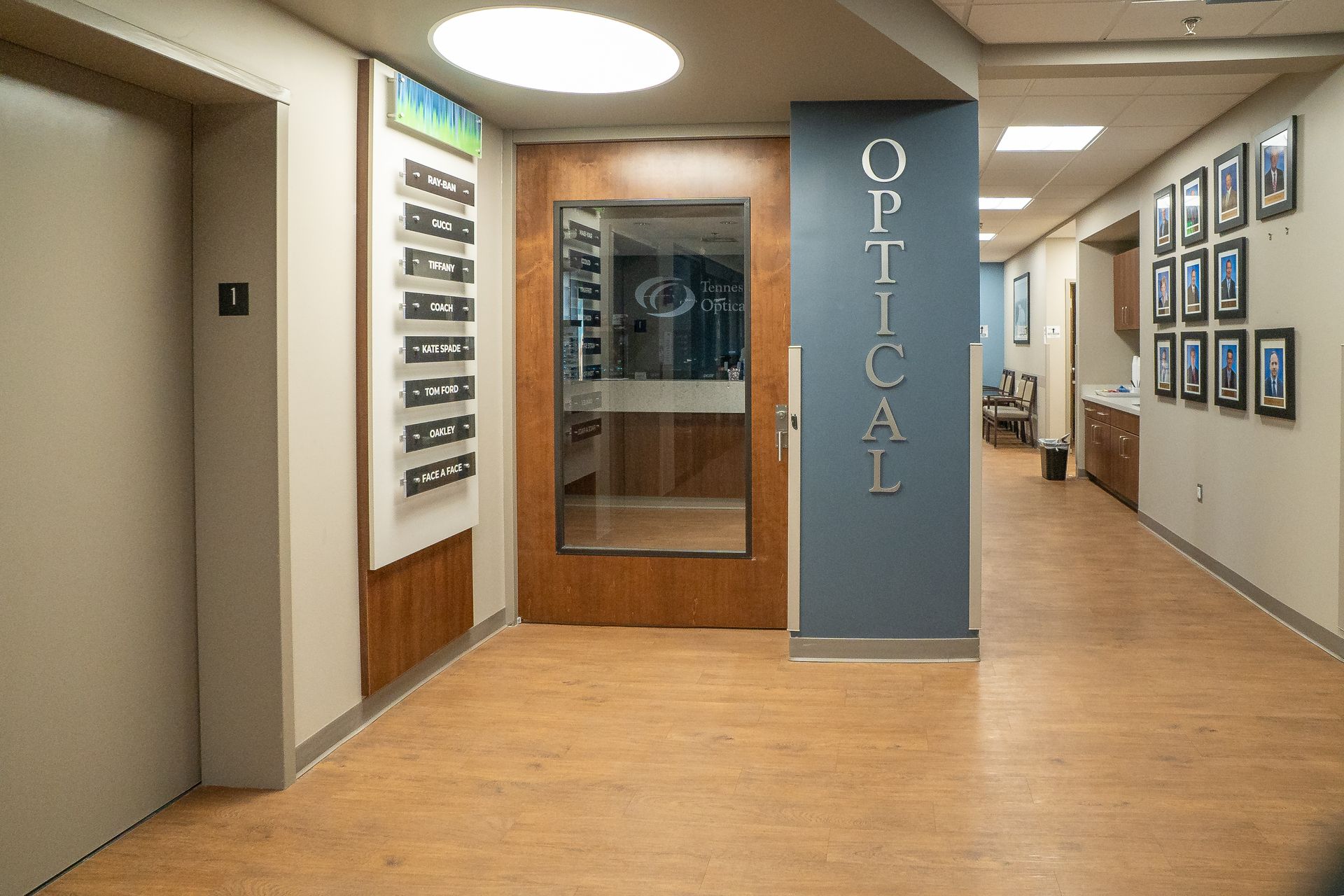 A hallway with a sign on the wall that says optical