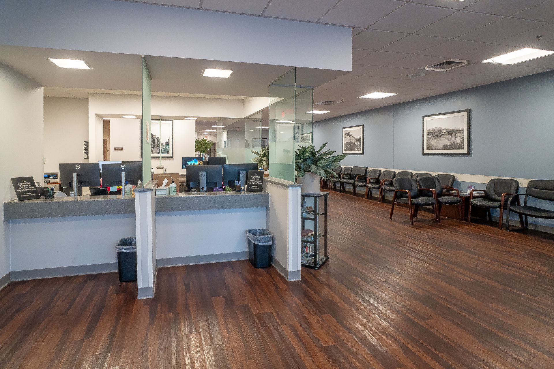 A waiting room with a counter and chairs in a hospital.