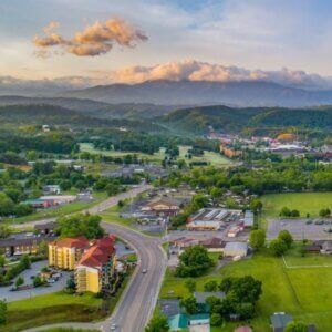 An aerial view of a small town with mountains in the background.