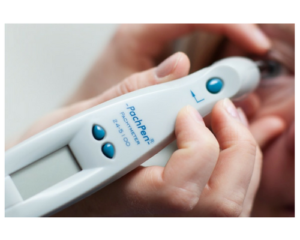 A person is holding a device that says ' peach pen ' on it