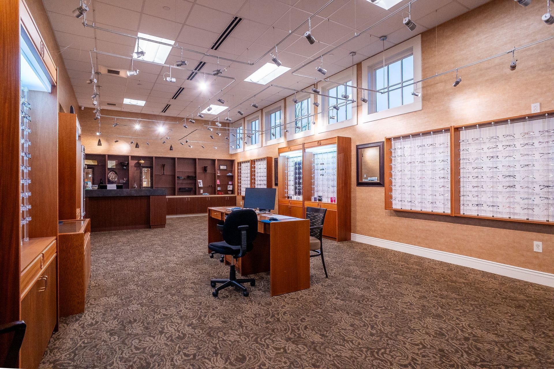 A large room with a desk and chair in it.