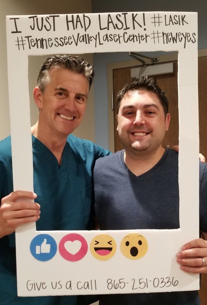 Two men holding a sign that says i just had lasik