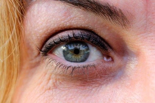 A close up of a woman 's eye with makeup on.