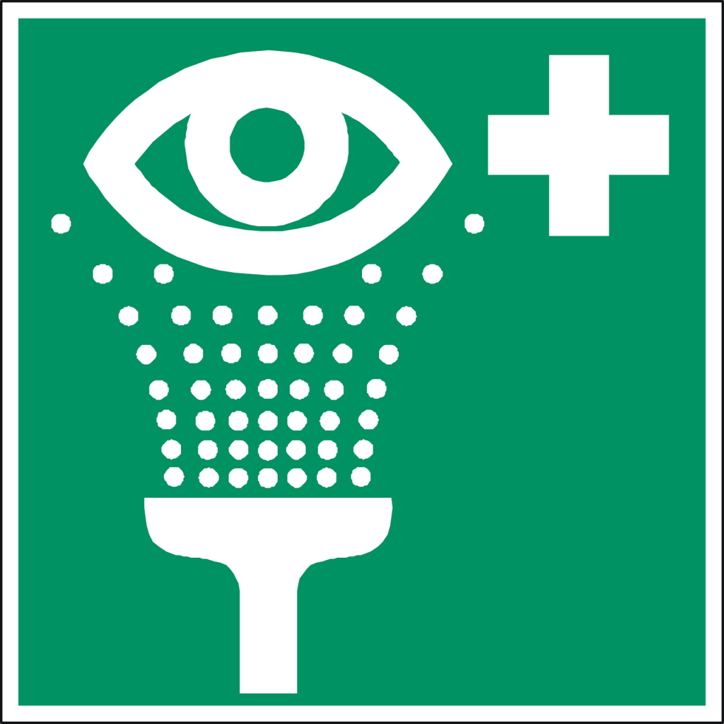 A green sign with an eye and a cross on it.