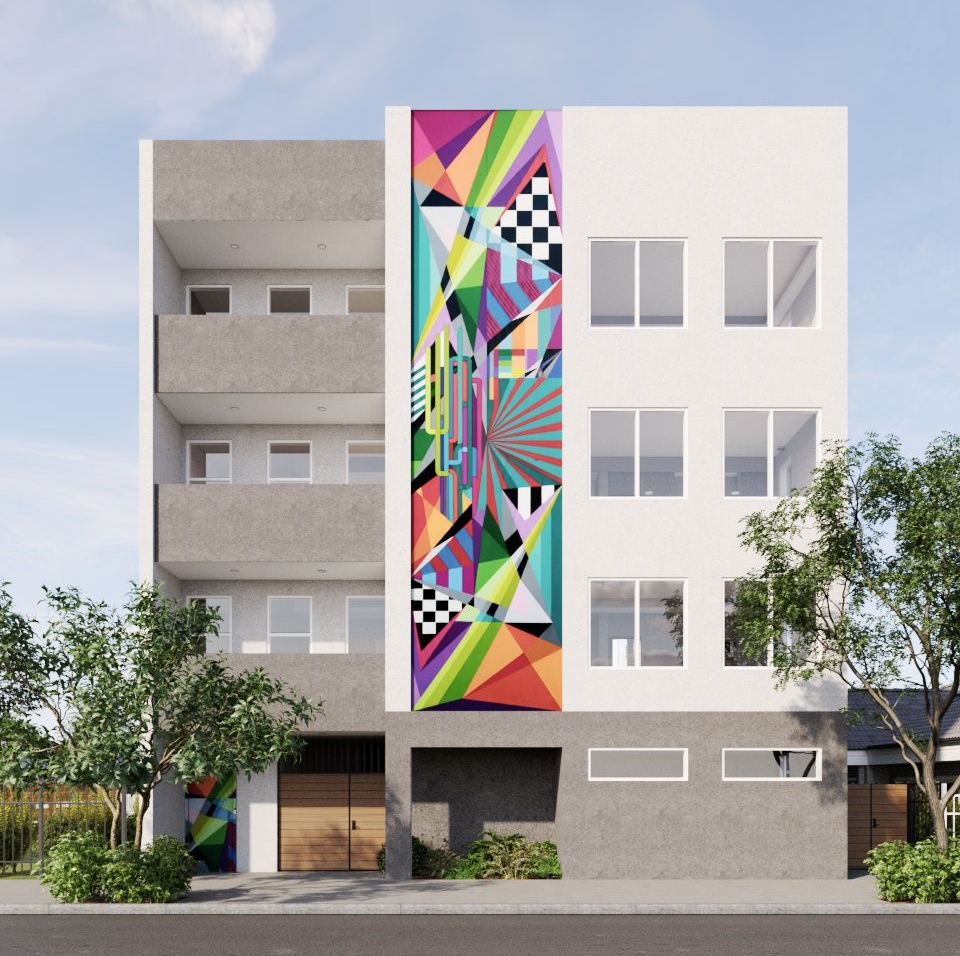 A modern, four-story apartment building with a vibrant, geometric-patterned mural on its white facade.