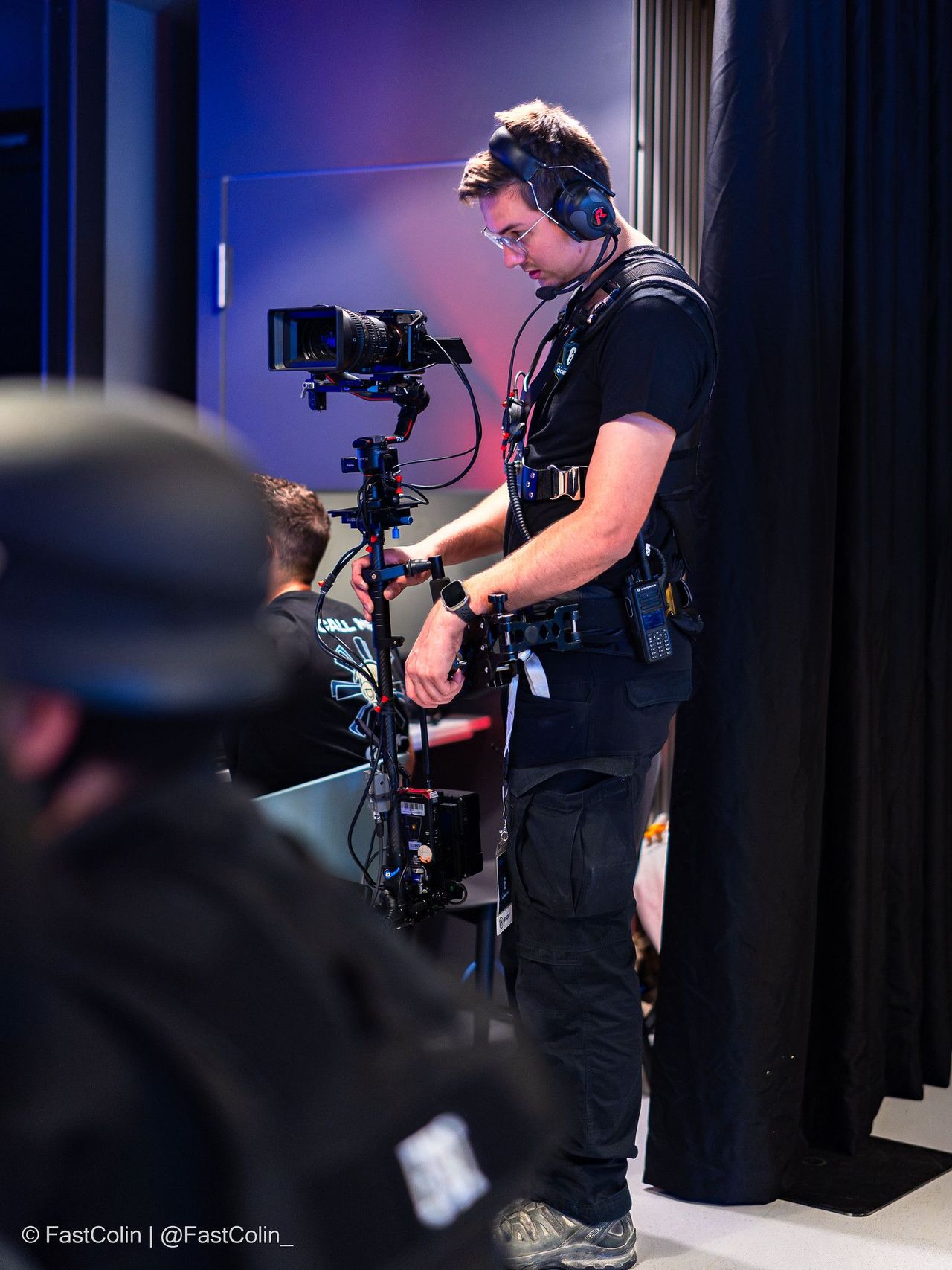 Camera operator with shoulder camera backstage at the R6 Central Combine 2026