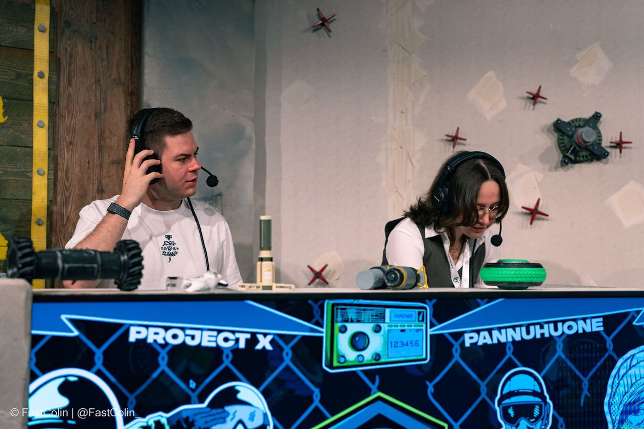 Two casters at the commentary desk during the grand final