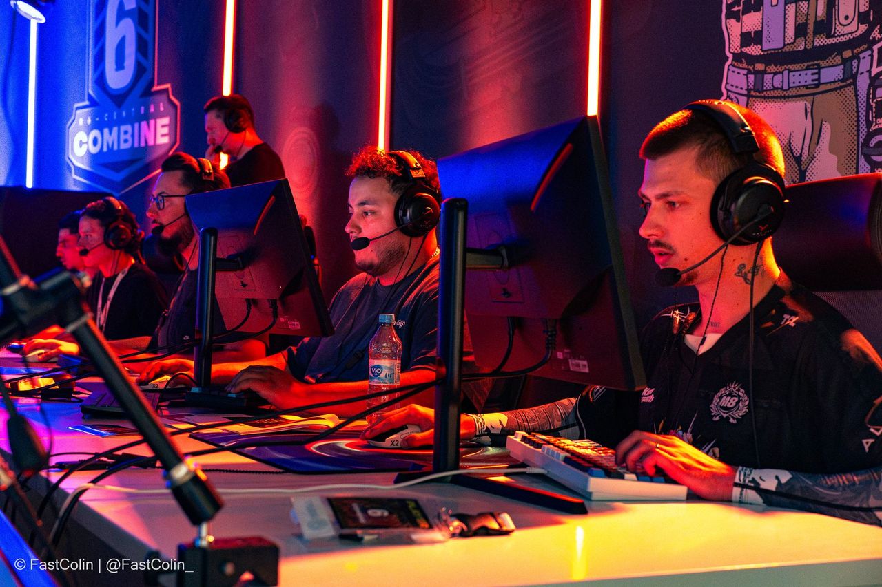 Players in a match on stage under red light