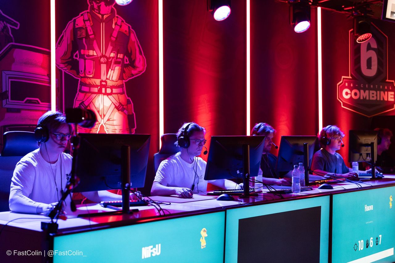 Stage with players under red light at R6 Central Combine