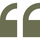 A pair of green quotation marks on a white background.