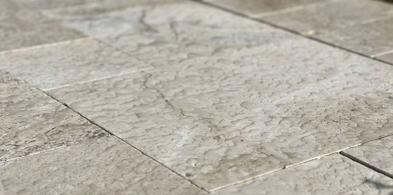 A close up of a sealed natural stone deck.