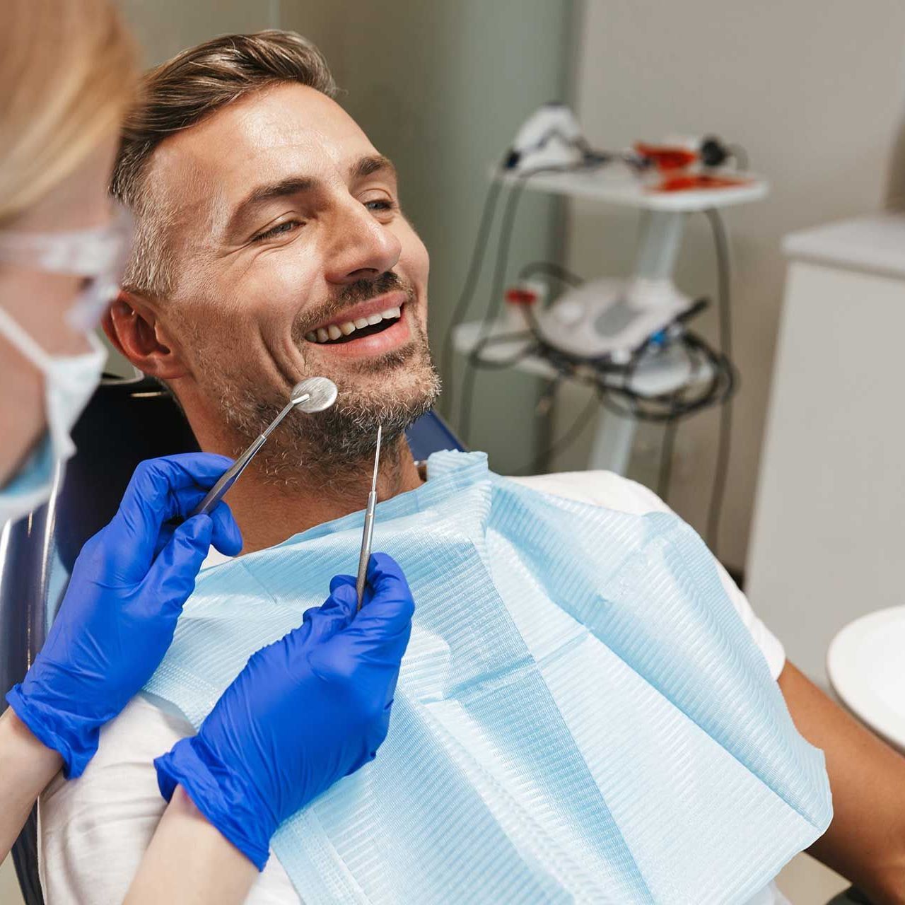 Happy young man sitting in medical dentist center.