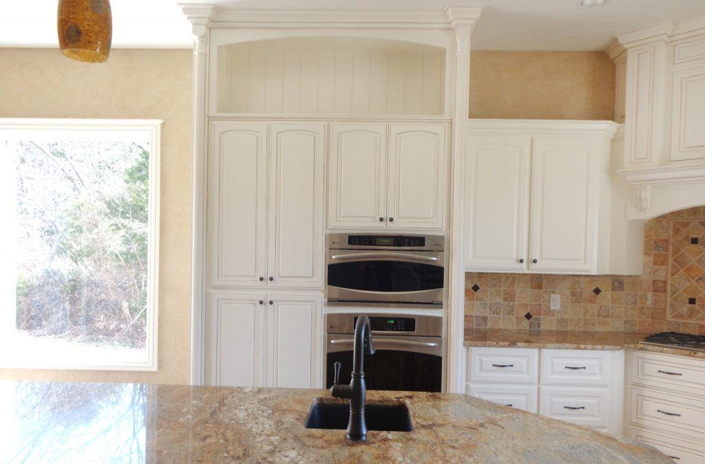 Kitchen With White Cabinets, Granite Countertops, Stainless Steel Appliances And A Sink  — Willard, MO — Bill’s Custom Woodworks