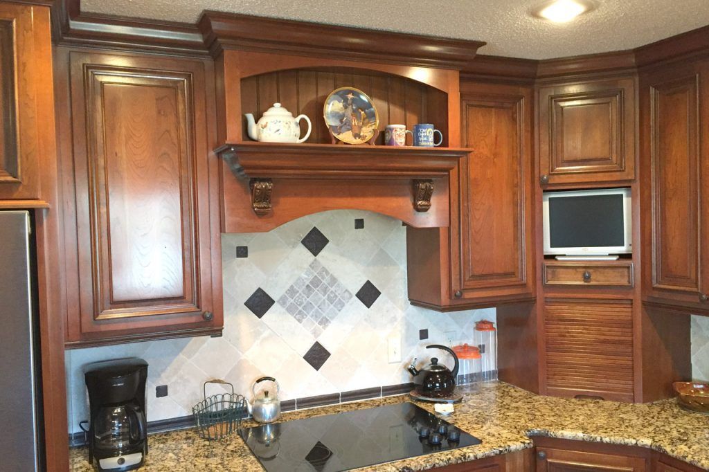 A Kitchen With Wooden Cabinets And Granite Countertops — Willard, MO — Bill’s Custom Woodworks
