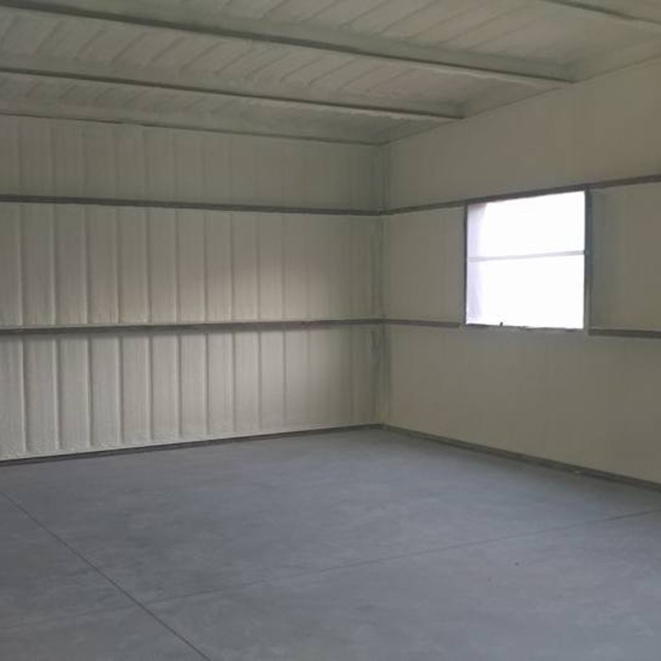Empty interior with concrete floor, white walls, and a window.