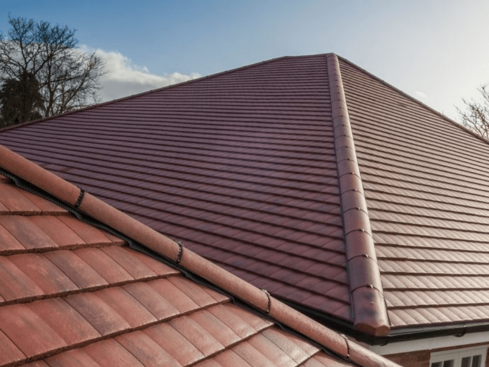 Picture of a new clay roof in dark red installed by Roofers Leeds